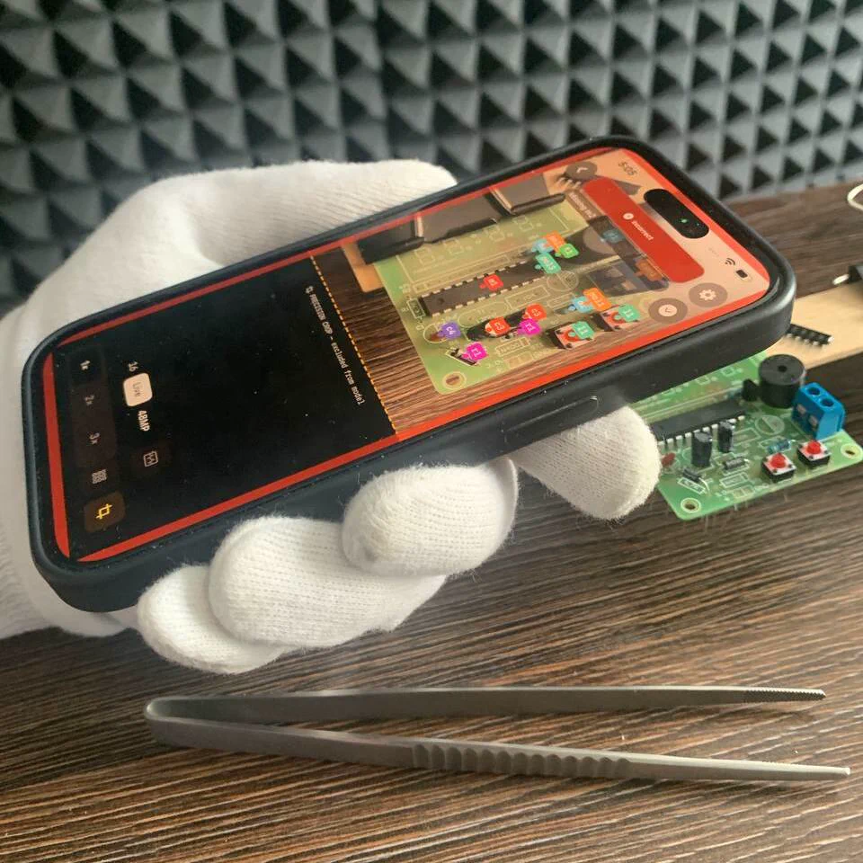 Inventor held by hand over a PCB, live verdict on screen
